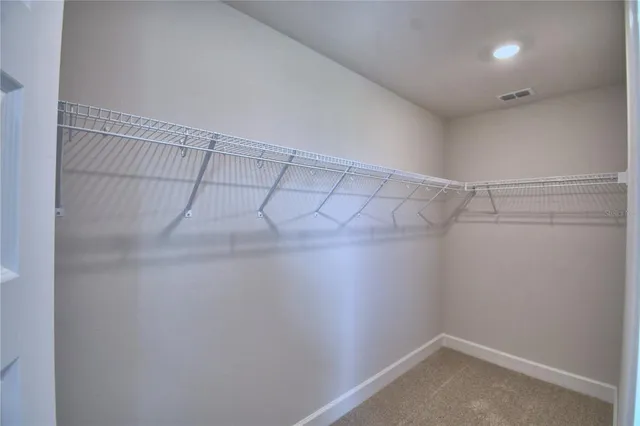 an empty room with closet and mirror