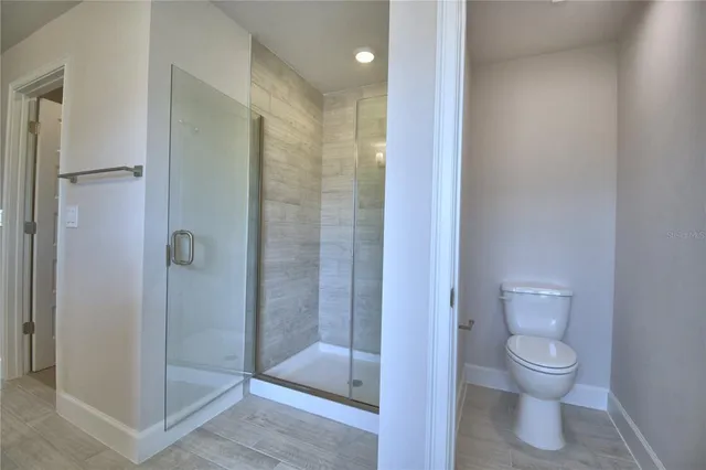 a bathroom with a bath tub a sink a window and a mirror