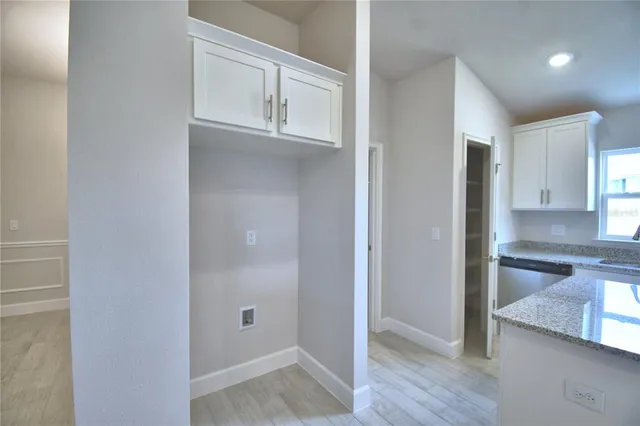 a view of a kitchen from the hallway with closet