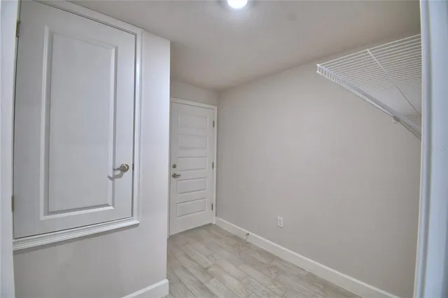 a view of walk in closet with wooden floor