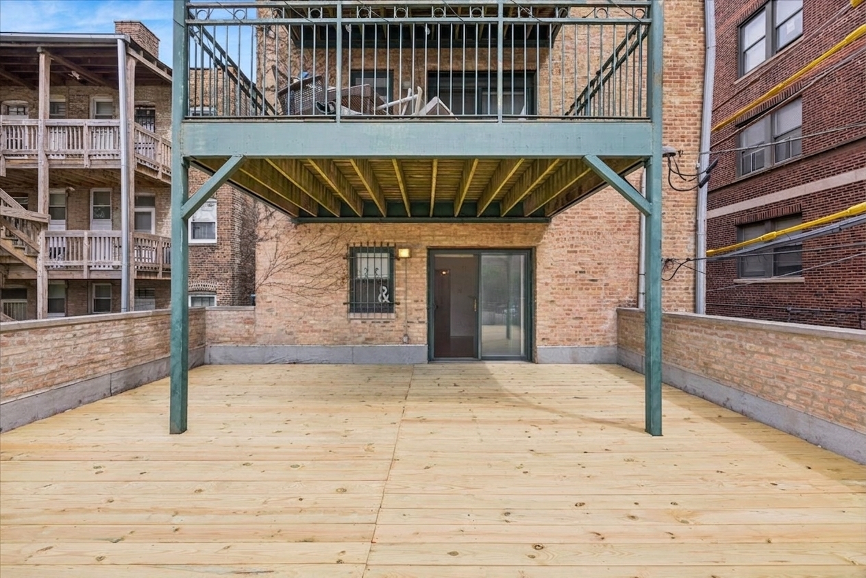 2363 East 70th Street, Unit 1 Chicago, IL 60649 - Photo 23 of 26 a front view of a house with a yard
