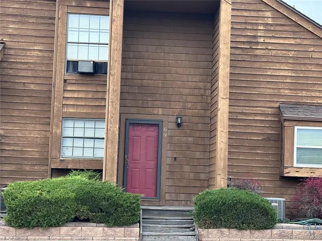 a view of a brick house with a large windows