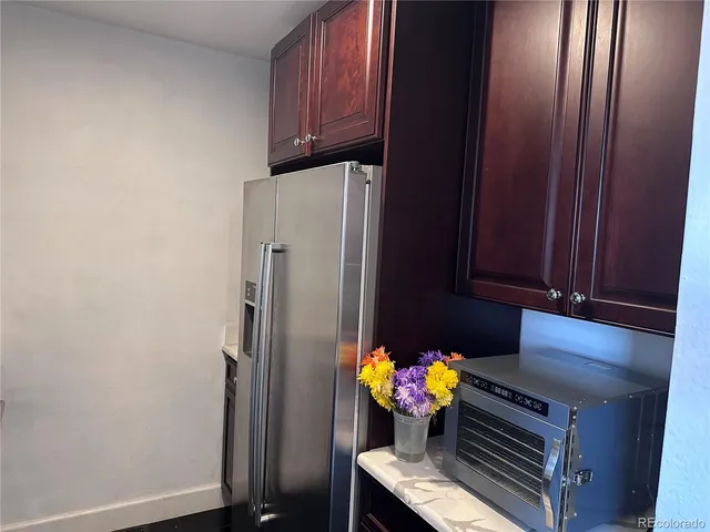 a kitchen with stainless steel appliances a refrigerator and a stove