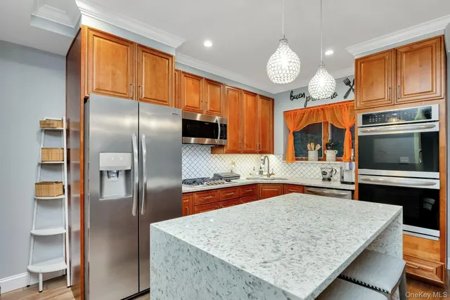 a kitchen with stainless steel appliances granite countertop a refrigerator oven a sink and dishwasher