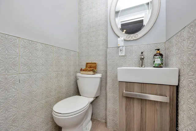 a bathroom with a toilet sink and mirror