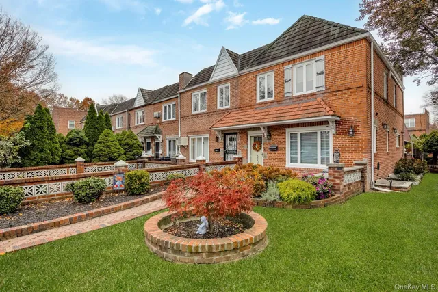 a front view of a house with a garden