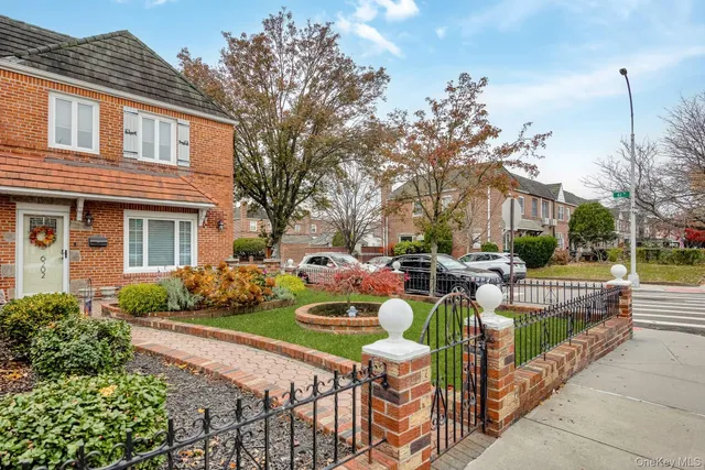 a front view of a house with patio furniture and garden