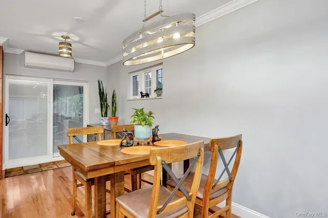 a view of a dining room with furniture and chandelier