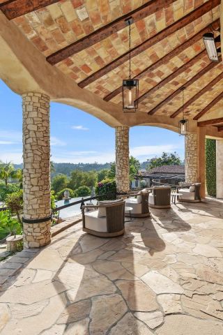 a view of a patio with a dining table and chairs with wooden floor and fence