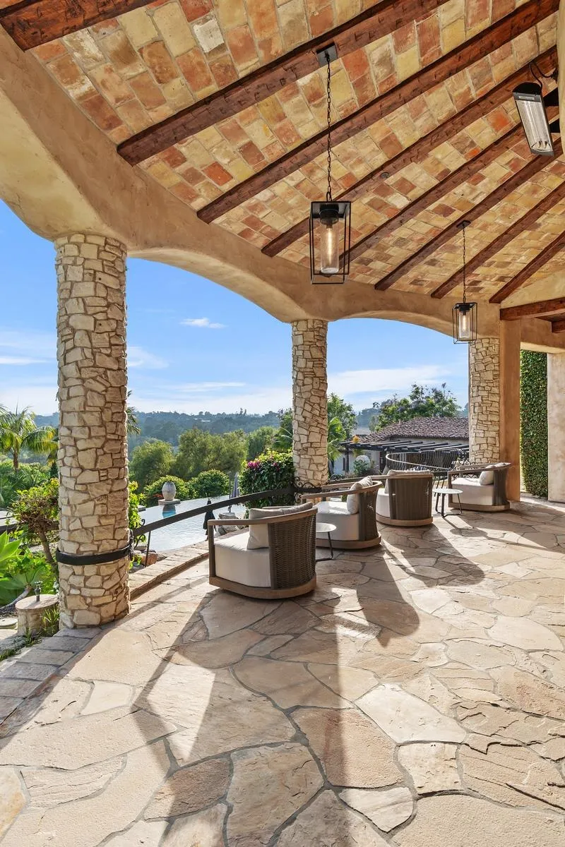 6720 Las Colinas Rancho Santa Fe, CA 92067 - Photo 14 of 36 a view of a patio with a dining table and chairs with wooden floor and fence
