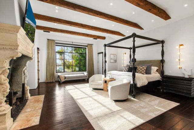 a bedroom with furniture and a window