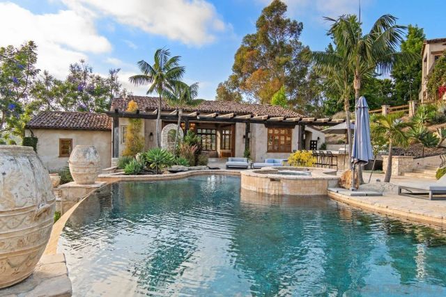 a swimming pool with outdoor seating and yard