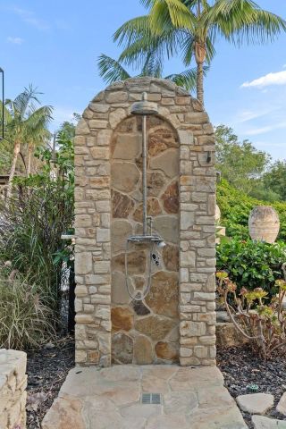 a living room with furniture a large window and stainless steel appliances