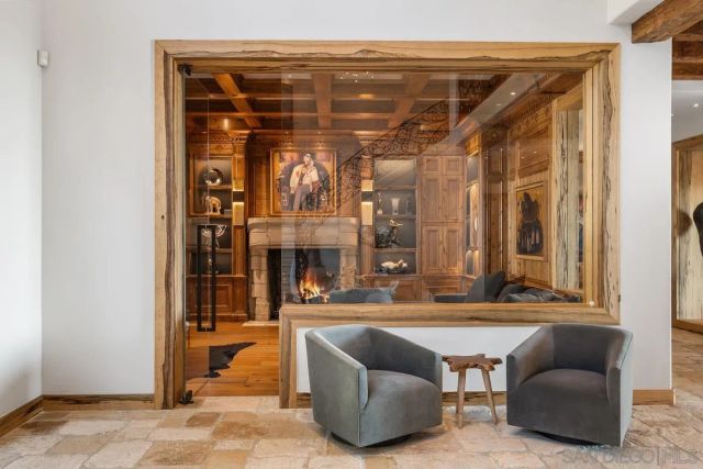 a living room with furniture a fireplace and a table