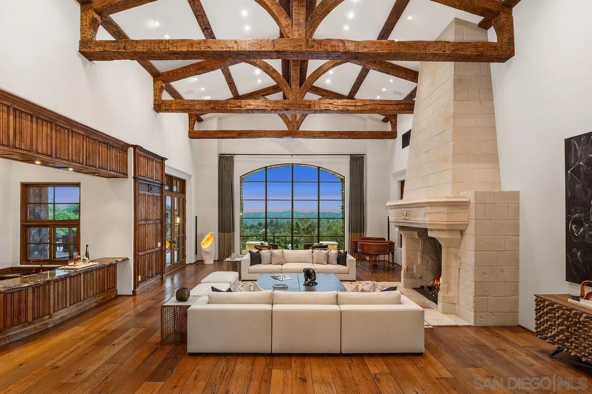 6720 Las Colinas Rancho Santa Fe, CA 92067 - Photo 5 of 36 a living room with furniture a fireplace and a flat screen tv