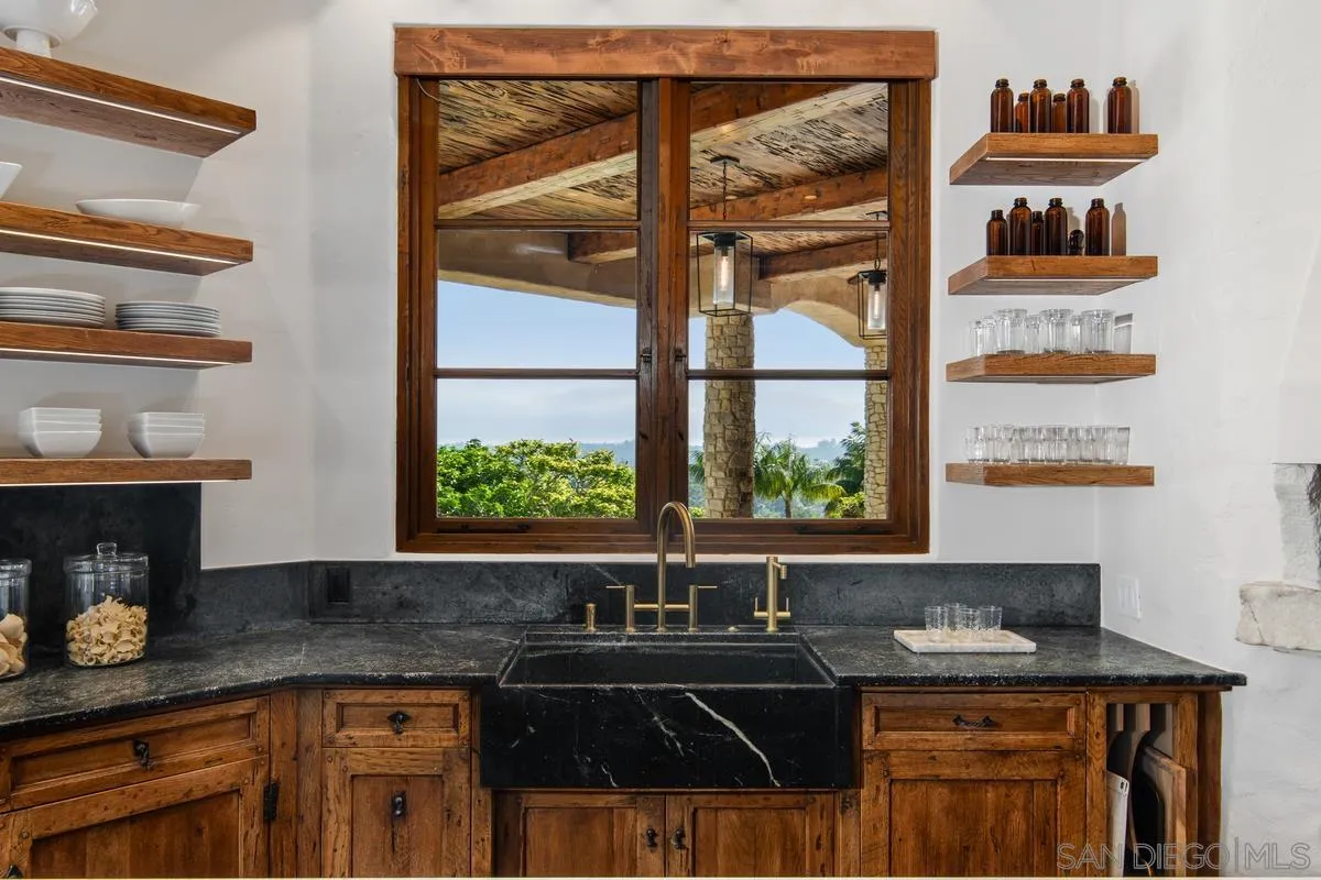 6720 Las Colinas Rancho Santa Fe, CA 92067 - Photo 9 of 36 a kitchen with granite countertop a sink and a window