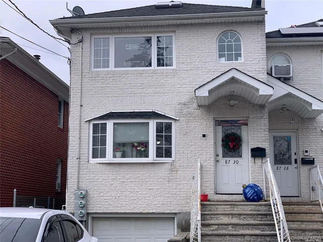 a front view of a house with stairs