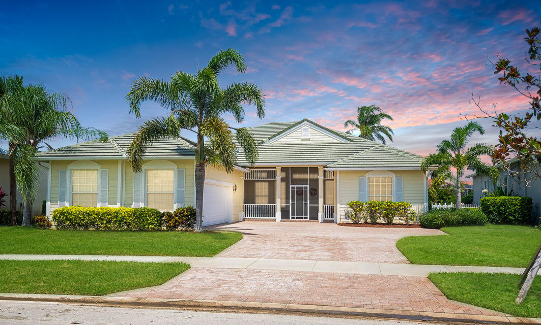 199 Magnolia Lakes Boulevard Port St. Lucie, FL 34986 - Photo 1 of 67 a front view of a house with a garden and plants
