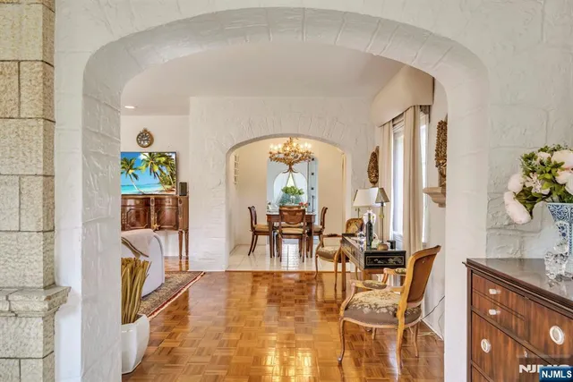 a view of staircase with lots of frames on wall and a window