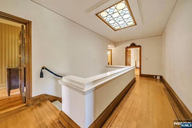 a bedroom with a bed lamp and a large window