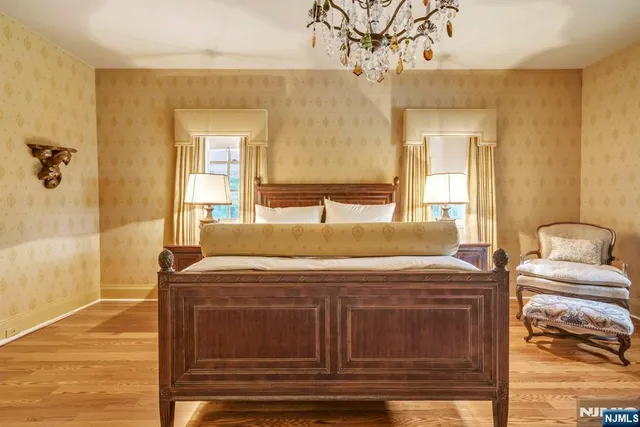 a bed room with a bed and a chandelier