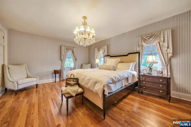 a spacious bathroom with double vanity sinks a mirror and a shower