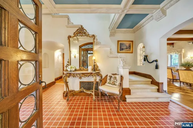 a living room with furniture a dining table and a rug