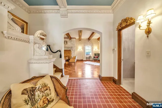 a living room with couches a dining table and chairs with wooden floor