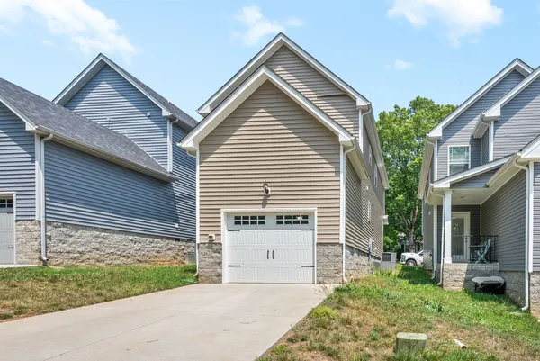 a front view of a house with a garden and yard