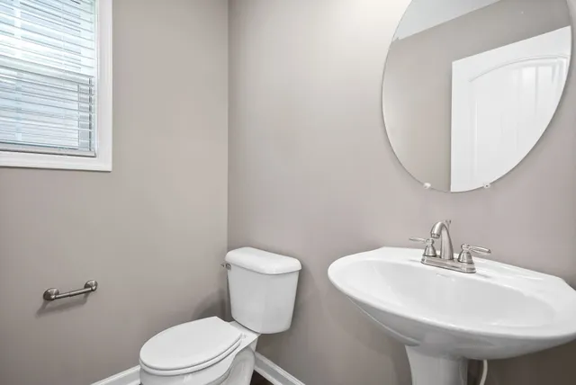 a white toilet sitting next to a white sink