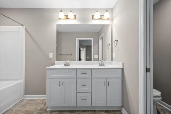 a bathroom with a sink vanity and mirror