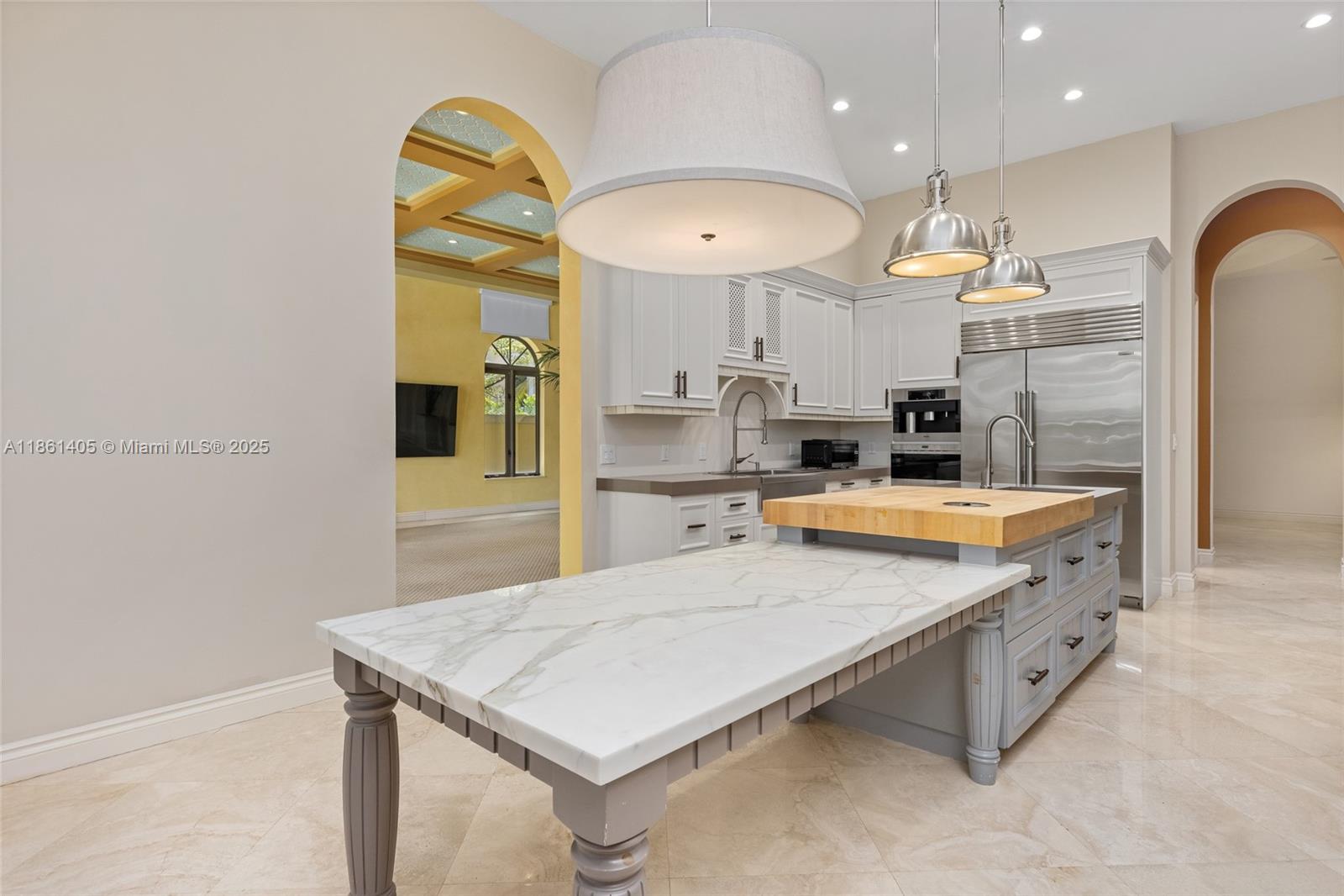 1504 Island Boulevard Aventura, FL 33160 - Photo 11 of 39 a kitchen with stainless steel appliances a sink a stove top oven a chimney and a refrigerator