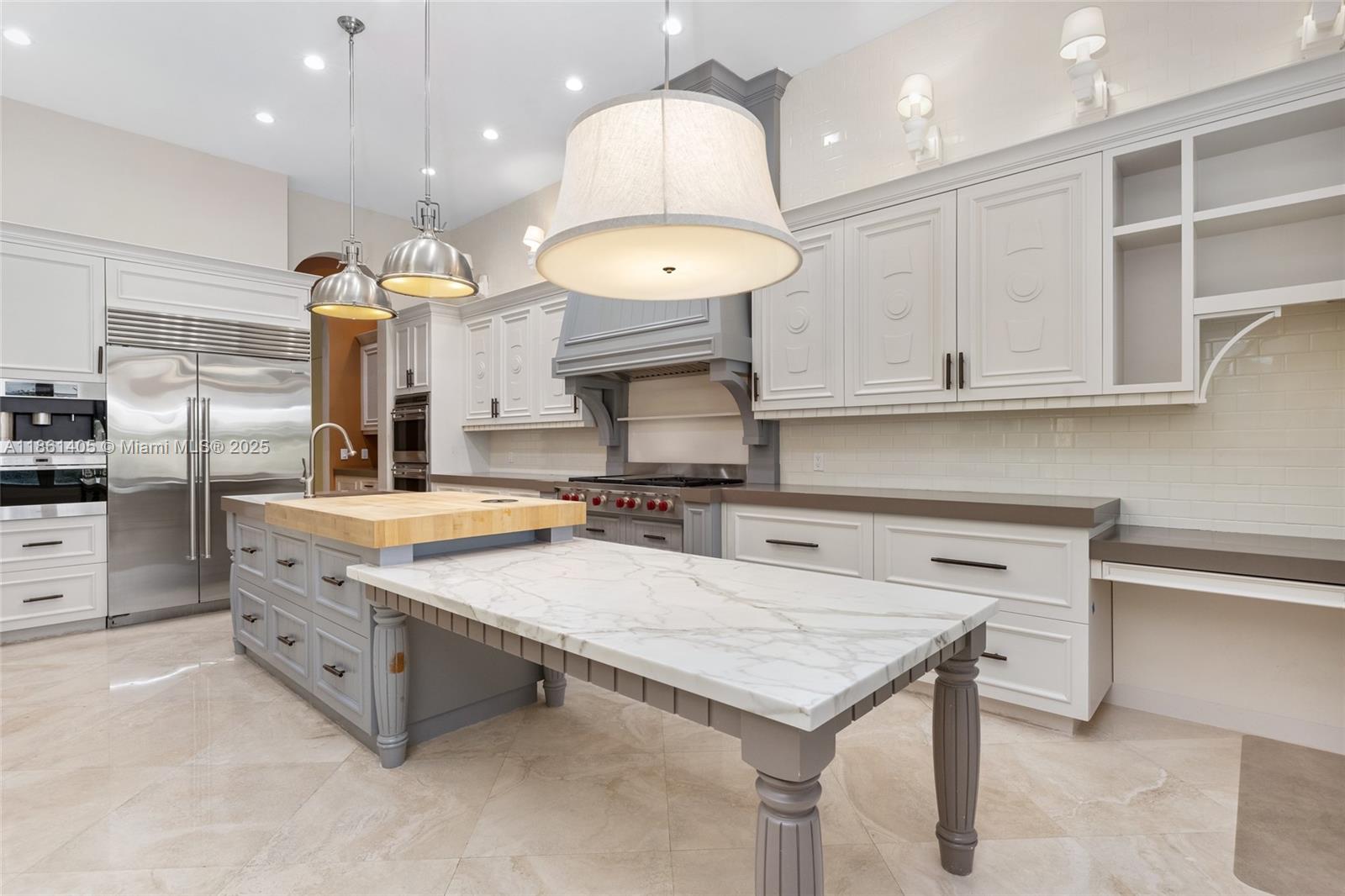 1504 Island Boulevard Aventura, FL 33160 - Photo 8 of 39 a kitchen with cabinets and chandelier