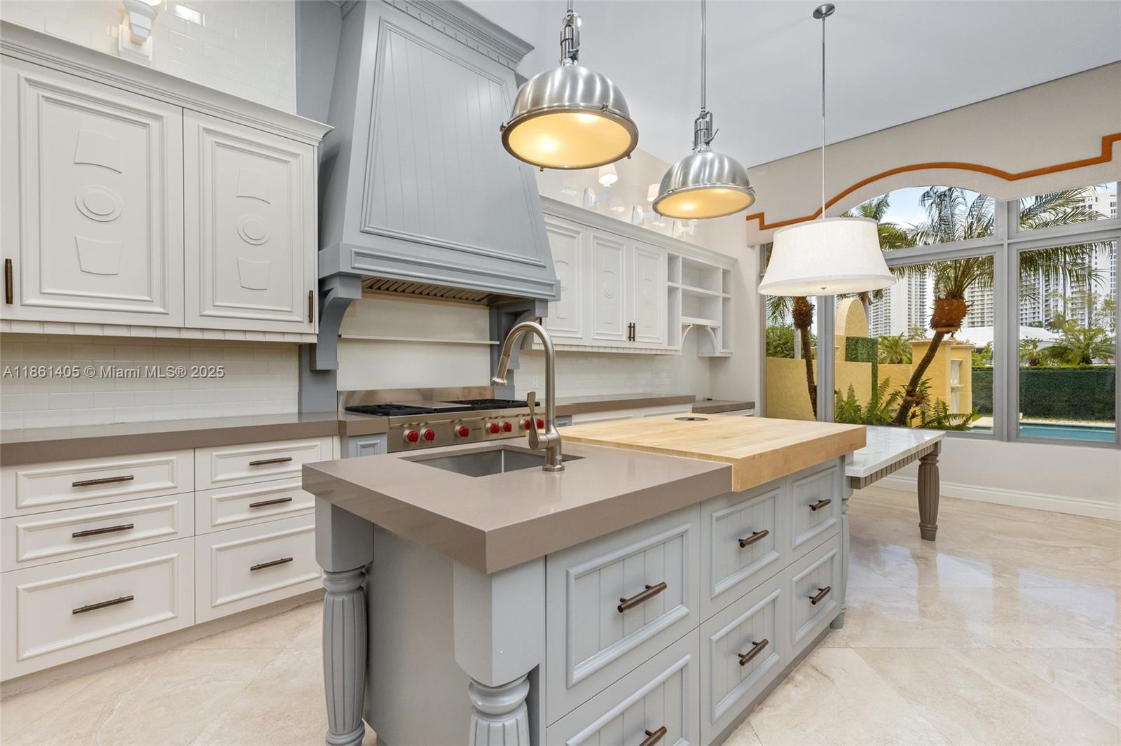 1504 Island Boulevard Aventura, FL 33160 - Photo 10 of 39 a kitchen that has a lot of cabinets in it