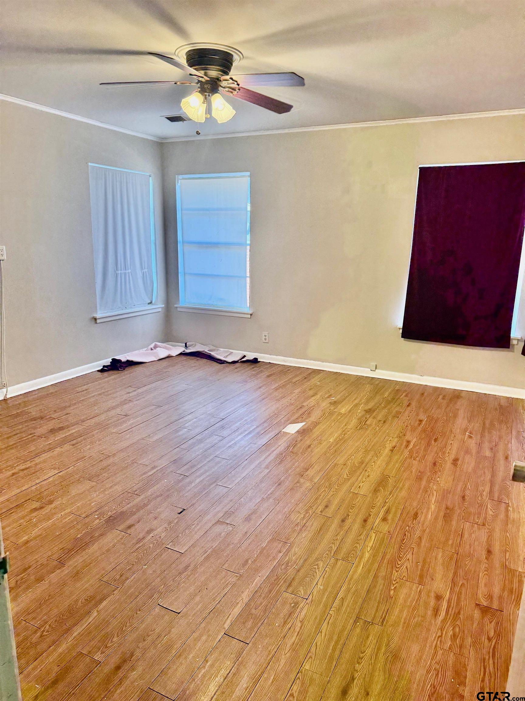 2408 Hunter Street Tyler, TX 75701 - Photo 13 of 33 an empty room with wooden floor and windows
