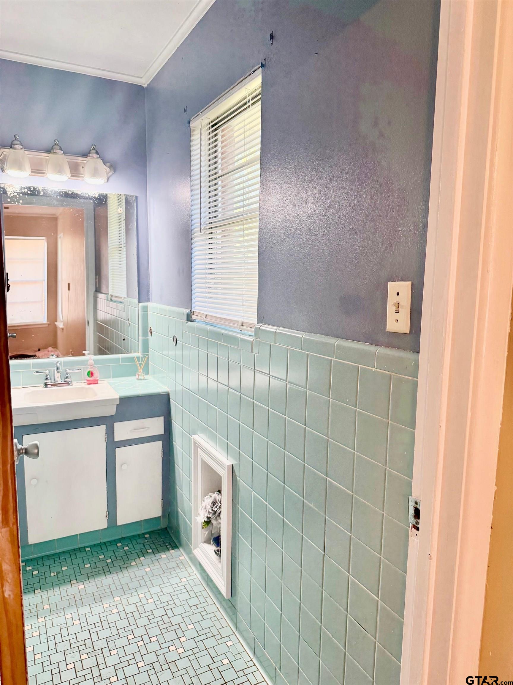 2408 Hunter Street Tyler, TX 75701 - Photo 15 of 33 a bathroom with a sink a toilet and mirror