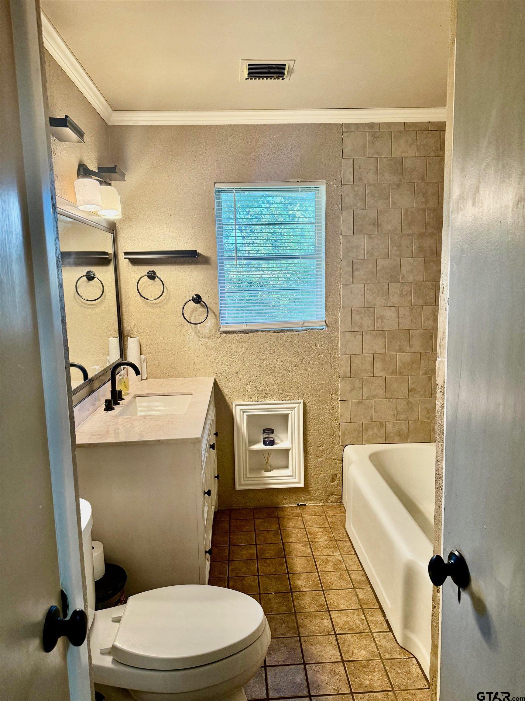 2408 Hunter Street Tyler, TX 75701 - Photo 21 of 33 a bathroom with a toilet and a shower