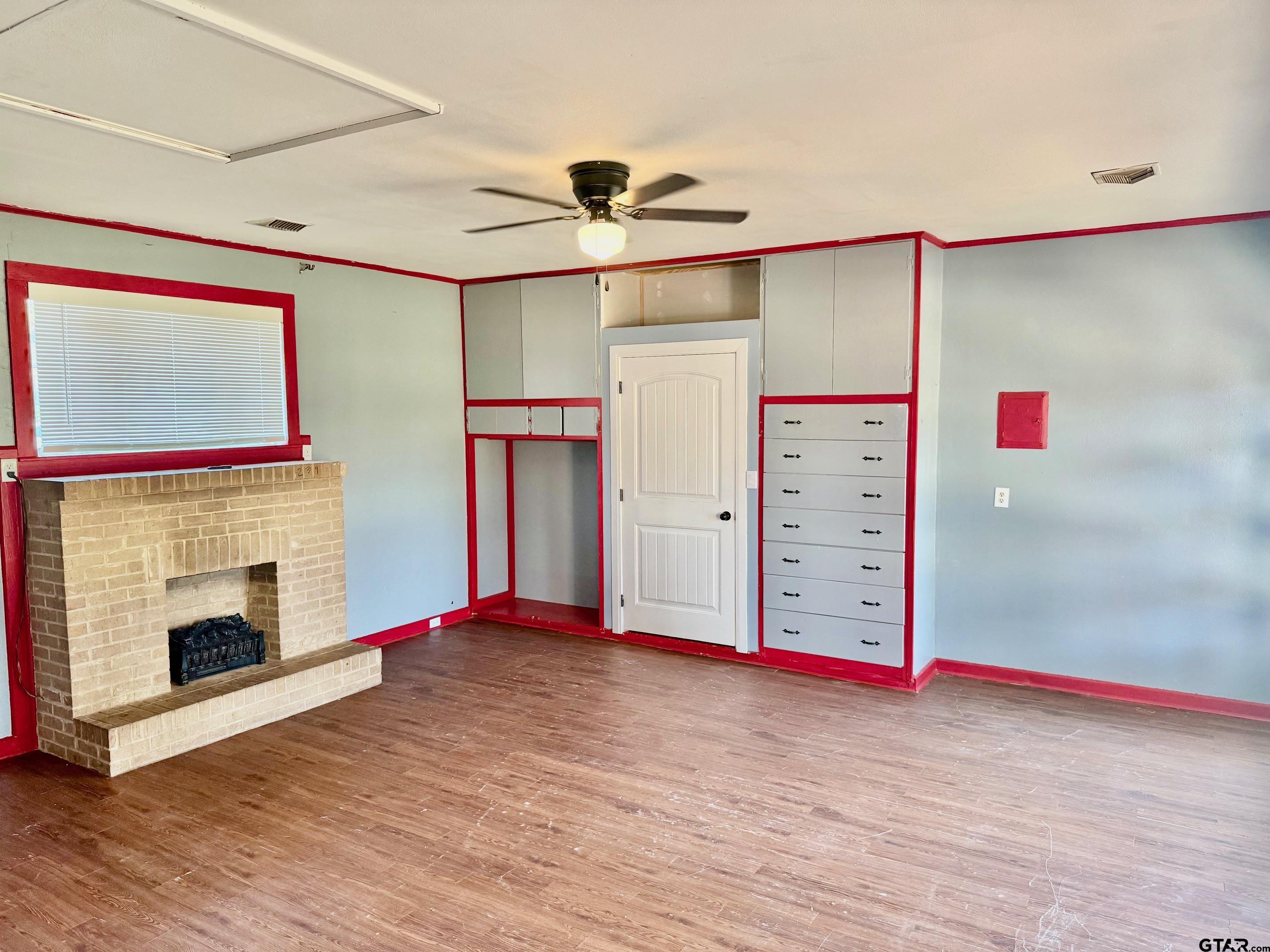 2408 Hunter Street Tyler, TX 75701 - Photo 24 of 33 a view of a livingroom with a fireplace ceiling fan and window