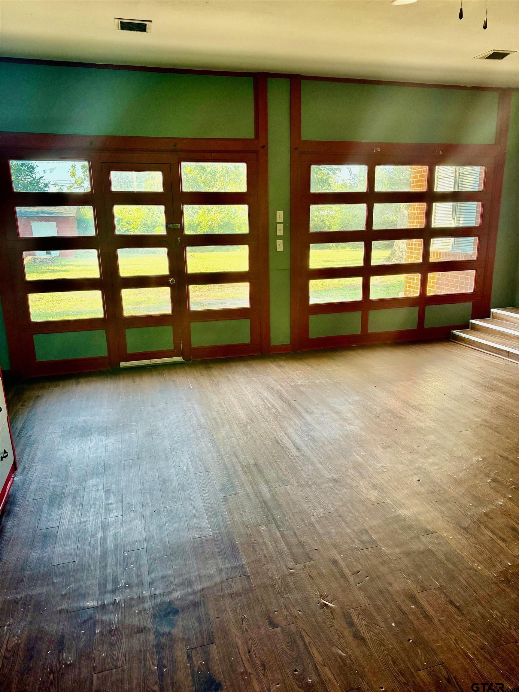 2408 Hunter Street Tyler, TX 75701 - Photo 26 of 33 wooden floor and window in an empty room