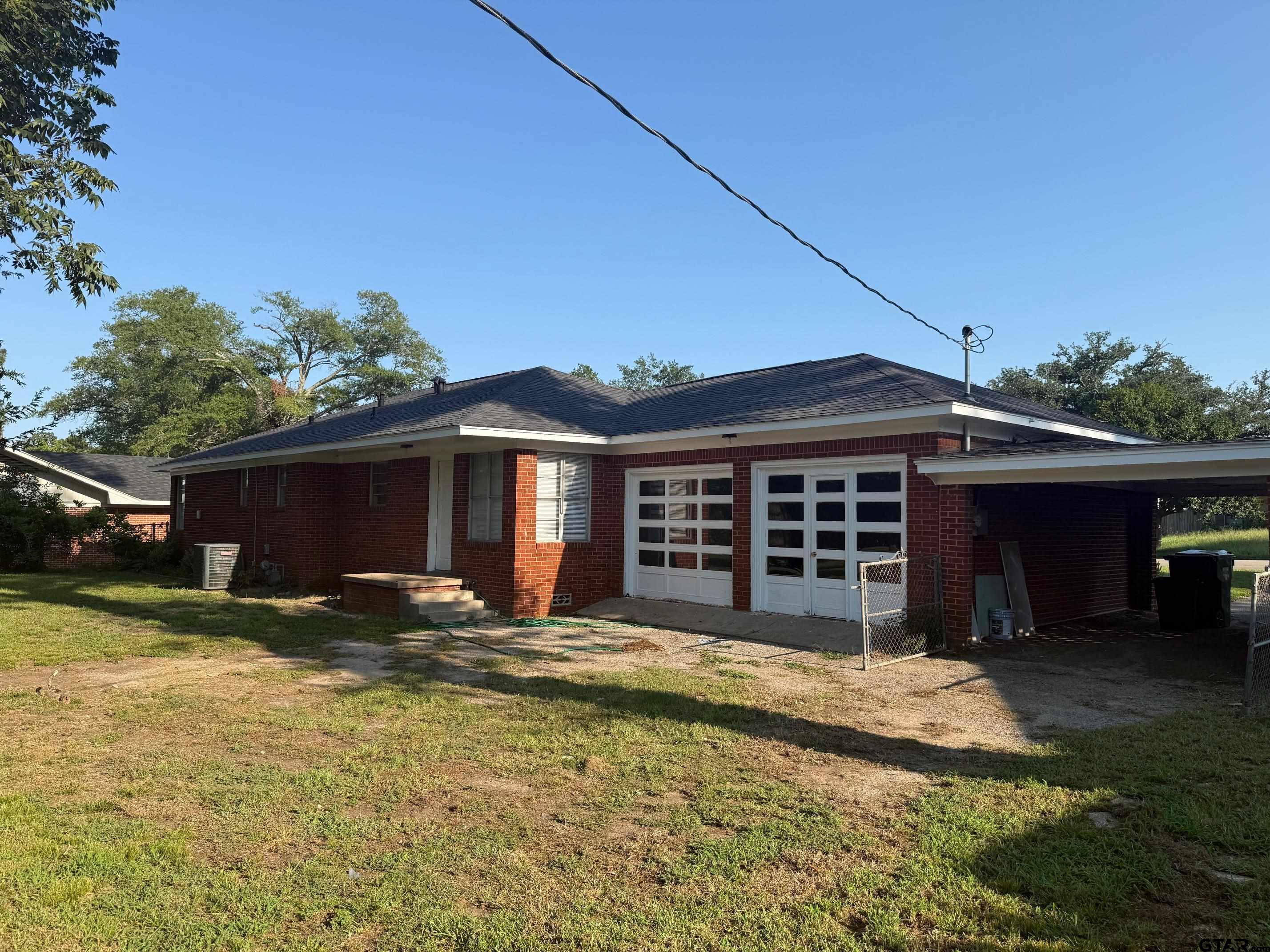 2408 Hunter Street Tyler, TX 75701 - Photo 30 of 33 a view of a house with a yard and garage