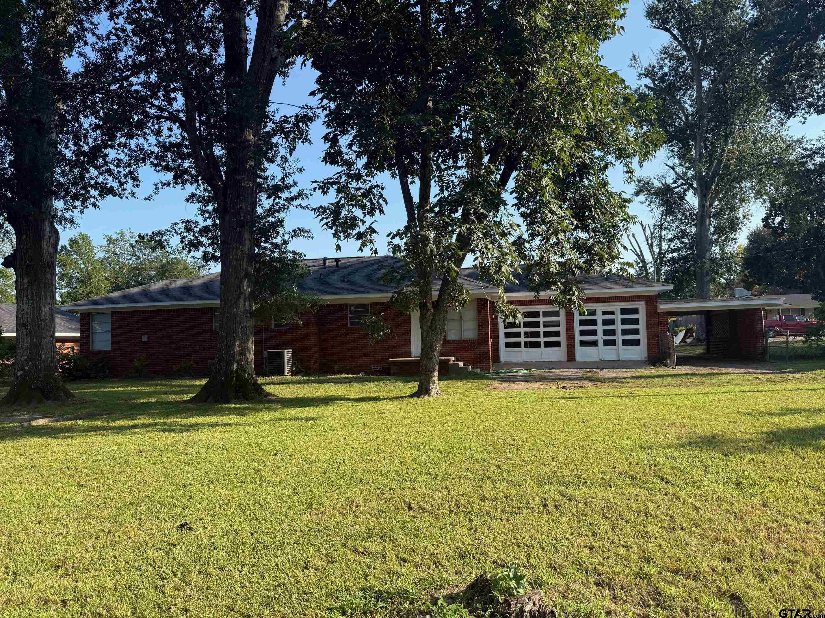 2408 Hunter Street Tyler, TX 75701 - Photo 32 of 33 a view of a house with a yard and large trees