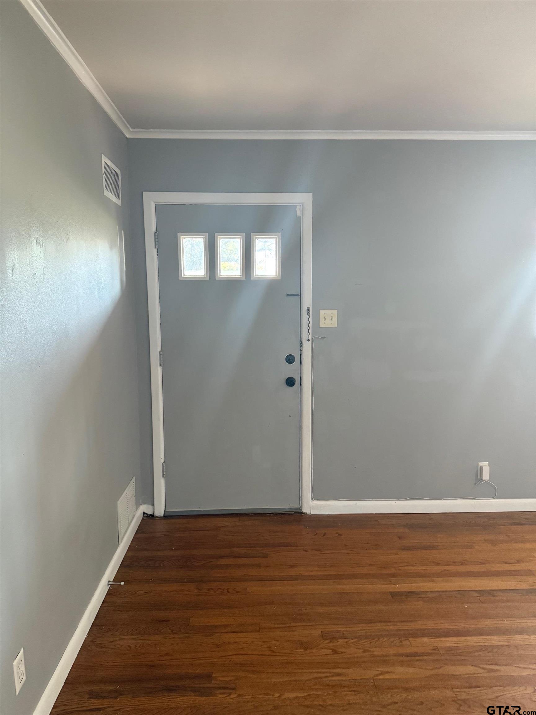 2408 Hunter Street Tyler, TX 75701 - Photo 4 of 33 a view of an empty room with wooden floor and a window