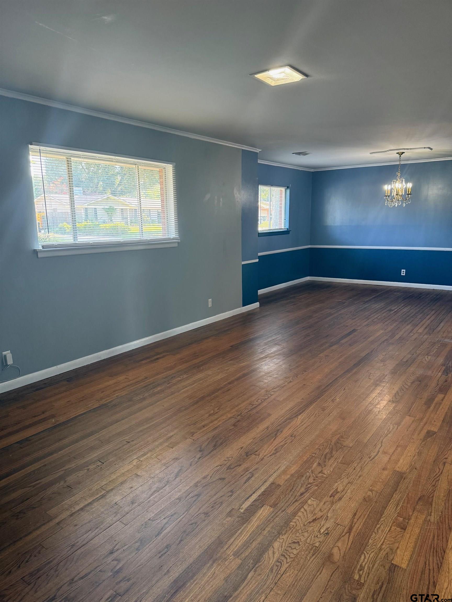 2408 Hunter Street Tyler, TX 75701 - Photo 5 of 33 a view of an empty room with wooden floor and a window