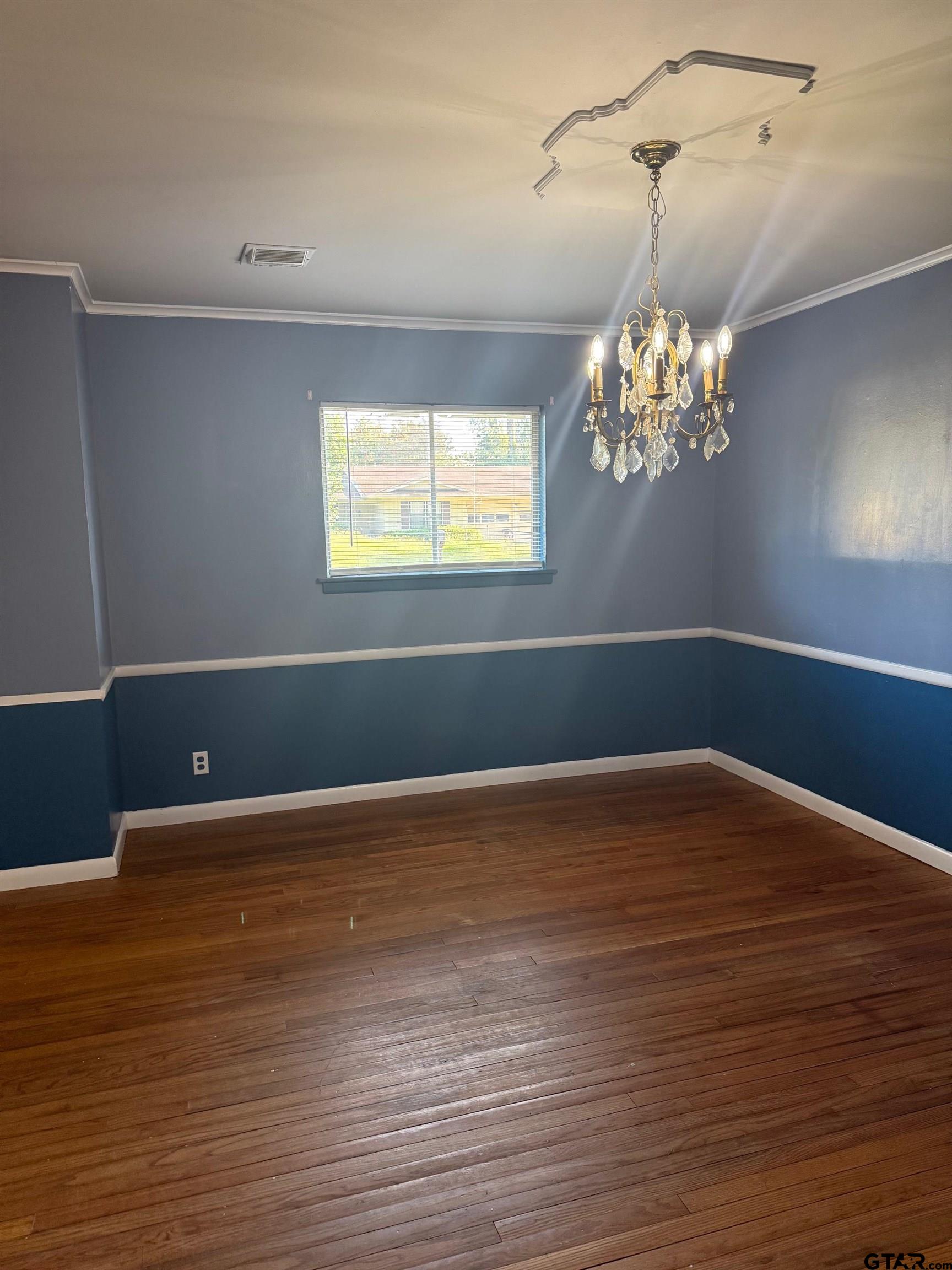 2408 Hunter Street Tyler, TX 75701 - Photo 7 of 33 a view of an empty room with wooden floor and a window