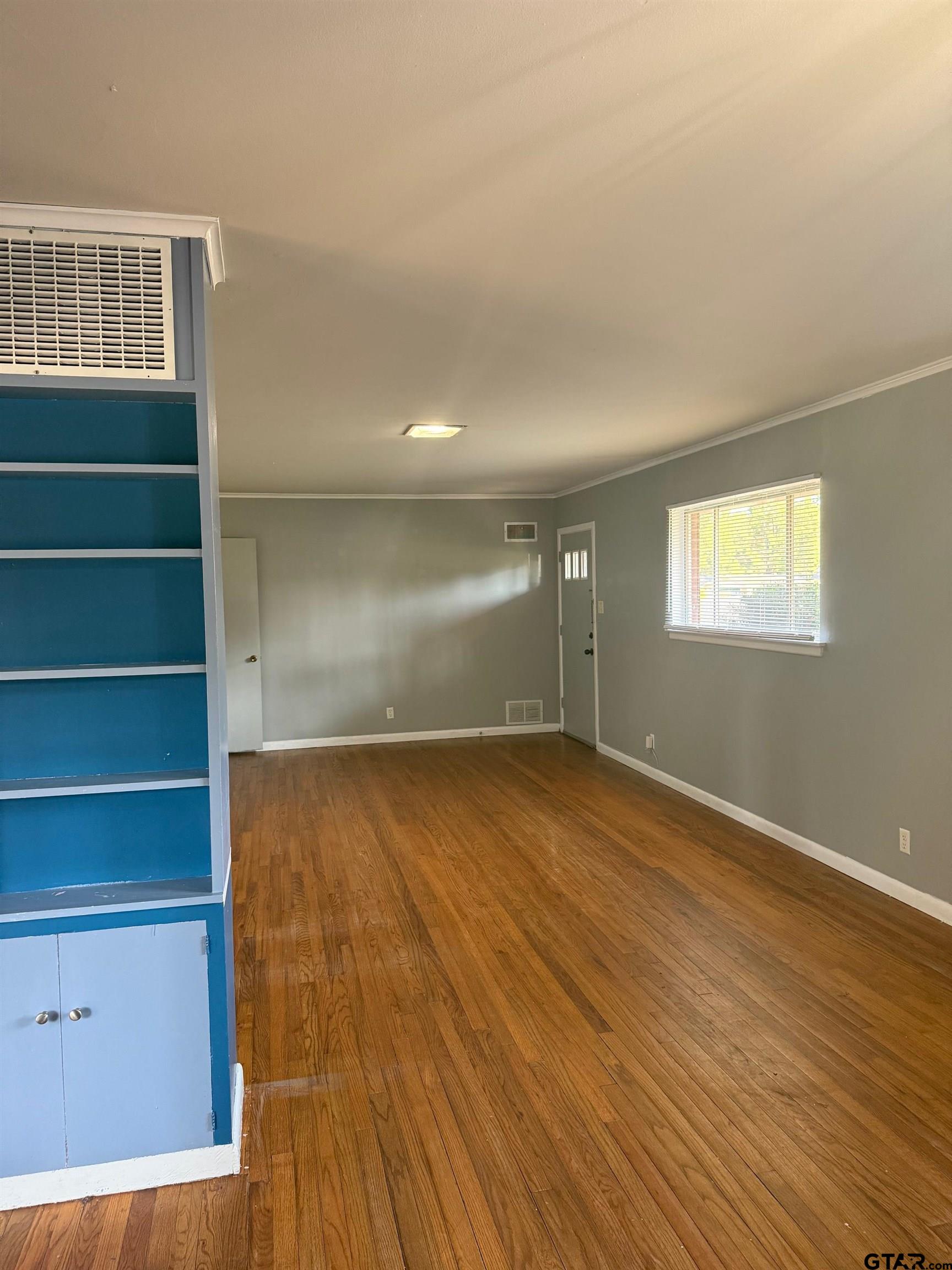 2408 Hunter Street Tyler, TX 75701 - Photo 8 of 33 a view of an empty room with wooden floor and a window