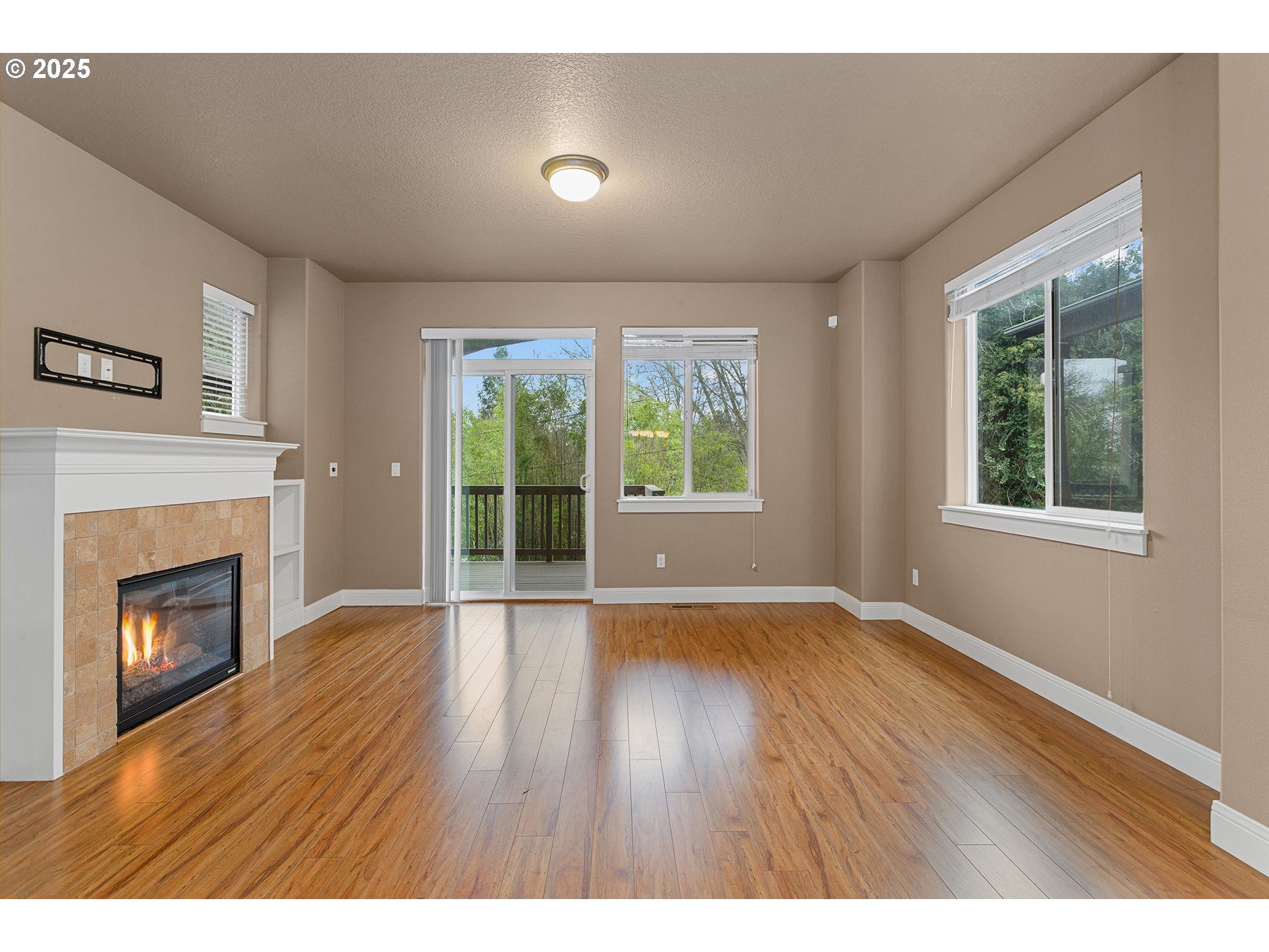 9622 Southwest Everett Terrace Tigard, OR 97223 - Photo 11 of 43 a view of an empty room with wooden floor and a window