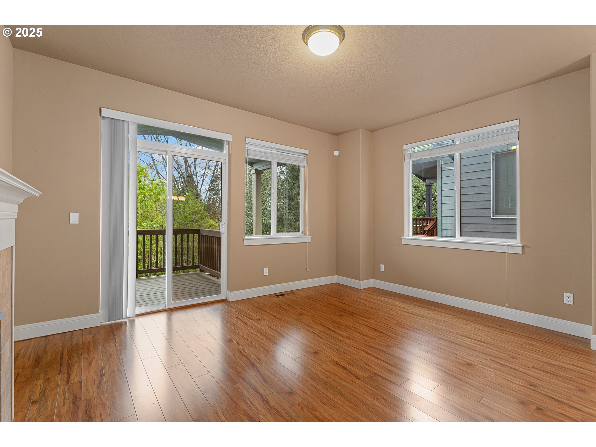 9622 Southwest Everett Terrace Tigard, OR 97223 - Photo 12 of 43 an empty room with wooden floor and windows