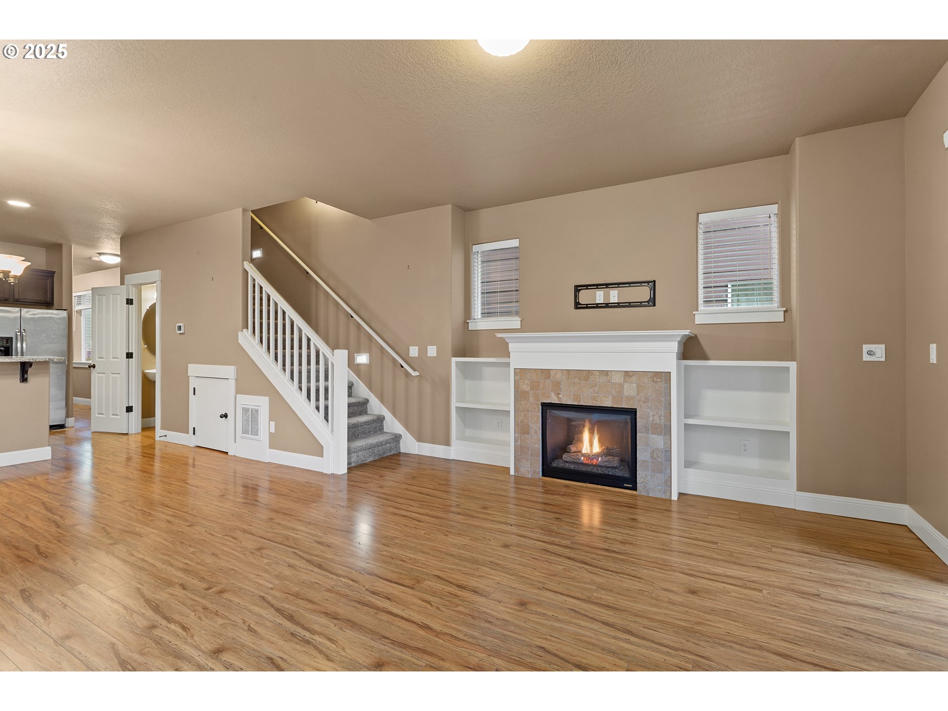 9622 Southwest Everett Terrace Tigard, OR 97223 - Photo 13 of 43 a view of an empty room with wooden floor fireplace and a window