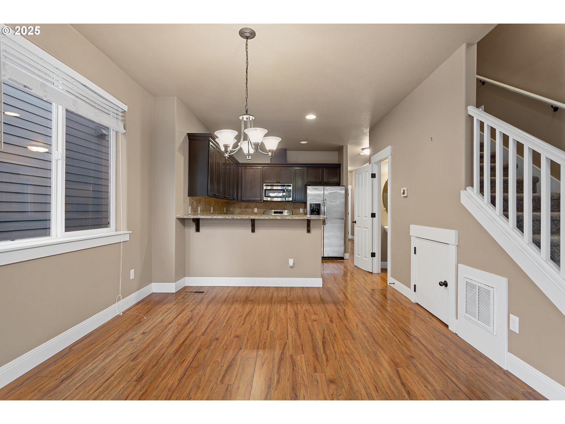 9622 Southwest Everett Terrace Tigard, OR 97223 - Photo 14 of 43 a view of a kitchen with a sink wooden floor and a chandelier