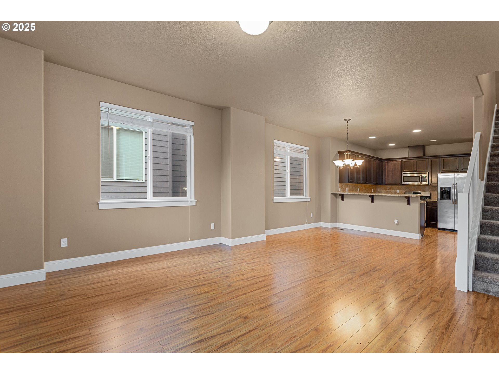 9622 Southwest Everett Terrace Tigard, OR 97223 - Photo 16 of 43 a view of an empty room with wooden floor and a window